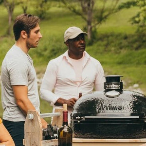 Outdoor gathering with Primo Grills Ceramic BBQ by the lake