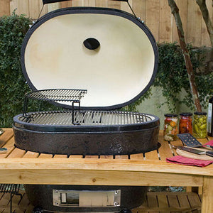 Premium Primo grill accessories on a wooden outdoor grilling station.