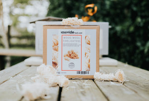 Kasai Wood Wool Firelighters - 200pcs box with scattered firelighters on table, ideal for eco-conscious fire lighting needs.