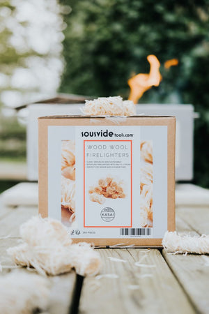 Kasai Wood Wool Firelighters - 200pcs box with firelighters in foreground, perfect for indoor and outdoor fire setups.