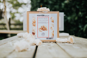 Kasai Wood Wool Firelighters - 200pcs box on outdoor table with firelighters around, designed for efficient and clean fire starting.