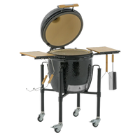 Monolith ONE 55 ceramic kamado grill with open lid and grilling tools attached, designed for premium outdoor cooking experiences.