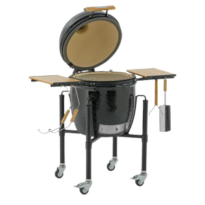 Monolith ONE 55 ceramic kamado grill with open lid and grilling tools attached, designed for premium outdoor cooking experiences.