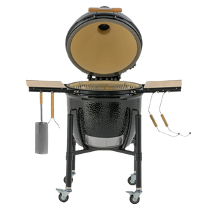 Monolith ONE.66 Ceramic Grill open front view showing interior grill grate, ceramic dome, and attached BBQ tools for outdoor cooking.