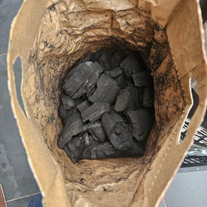 Open bag view of Premium Gourmet Lumpwood BBQ Charcoal showing dense hardwood chunks perfect for grilling and barbecuing.
