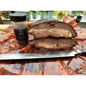 BBQ rub jar with grilled meat and outdoor setting