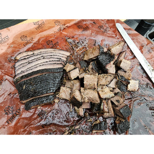 Sliced brisket on OREN Pink Butchers Paper Roll - BBQ Meat Smoking | FDA Approved, showing clean cuts and juicy texture ideal for BBQ presentation.