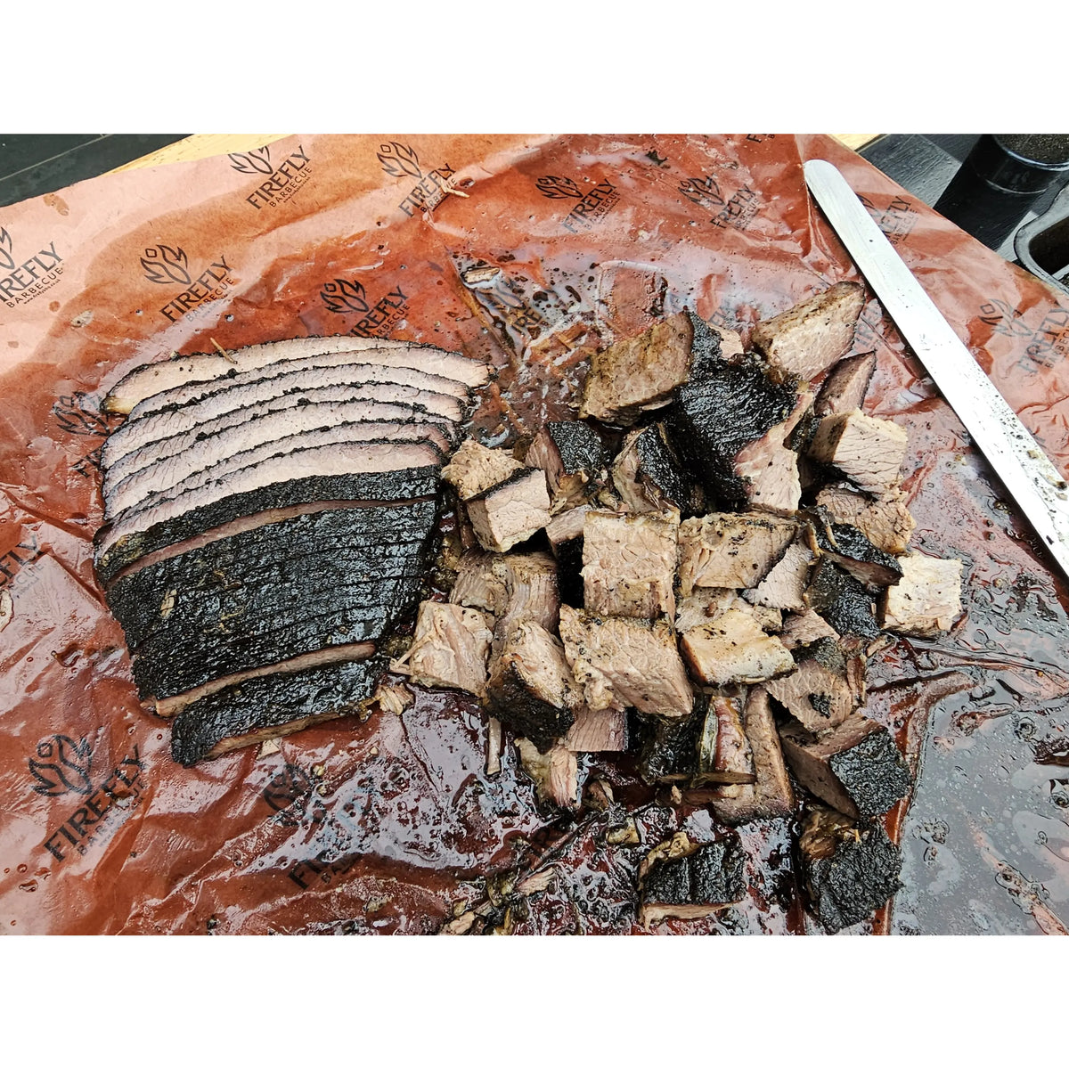 Smoked meat wrapped in pink butcher paper