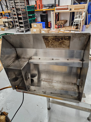 Interior view of Cookshack Smokehood 100 Series showing internal compartments and stainless steel construction for smoke extraction.