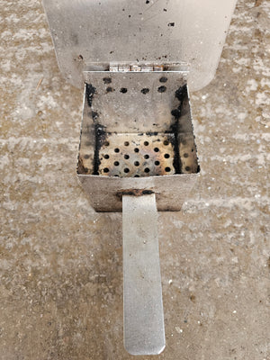 Interior of Cookshack Cold Smoke Kit, Series 200 smoke box with perforated base for even smoke distribution in outdoor grills.