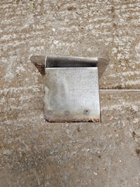 Metal corner bracket on rough concrete floor