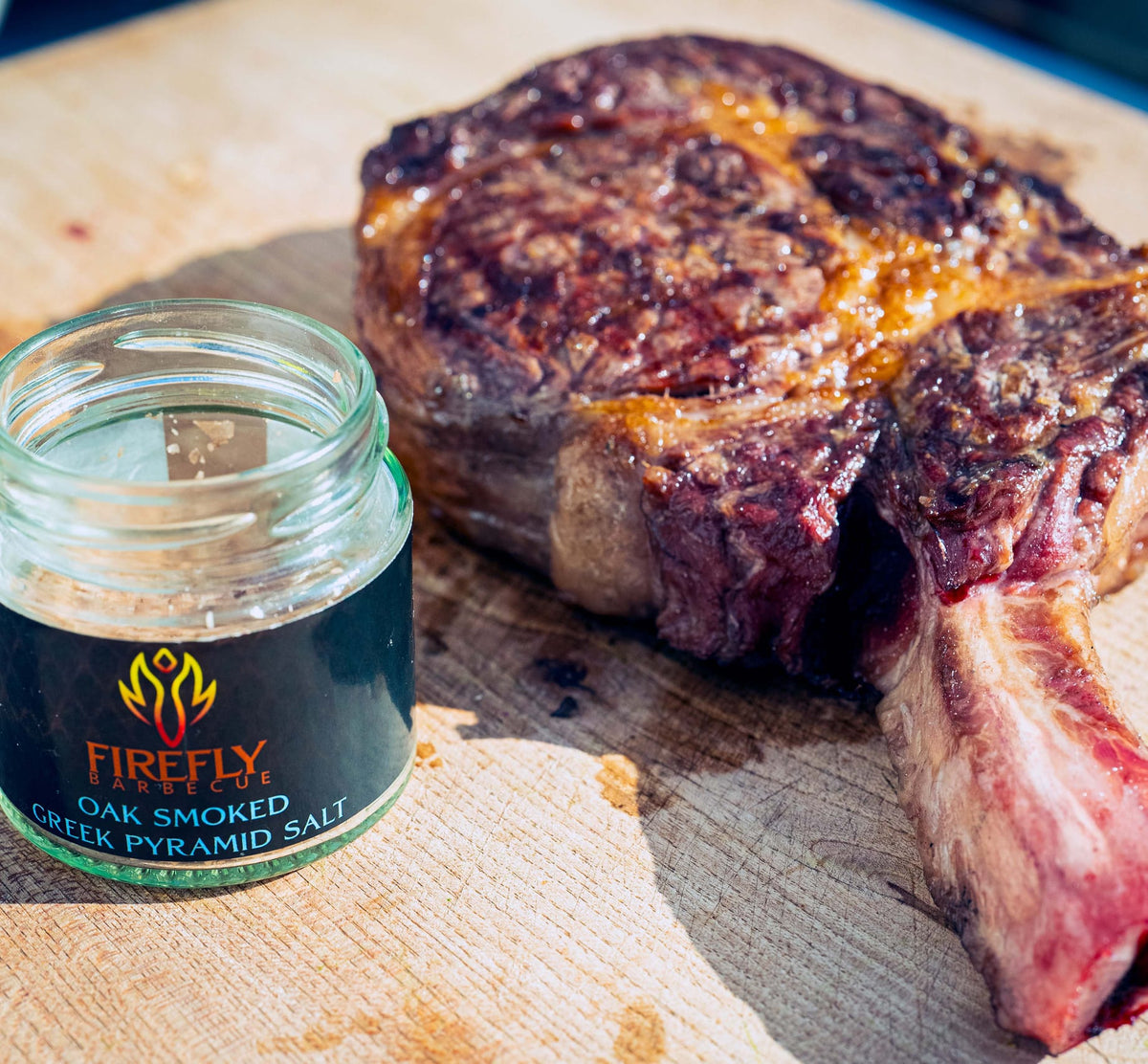 Firefly Barbecue Oak Smoked Greek Pyramid Salt on wooden surface