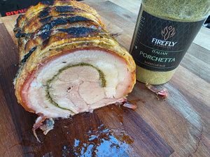 Cooked pork roast with herbs and spices on a wooden board