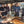 People gathered under canopy at outdoor BBQ with food and drinks