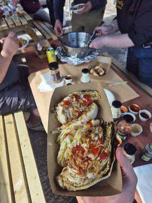 Close-up of BBQ food in takeout container with toppings
