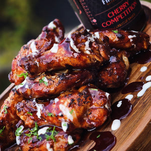Braised chicken wings with cherry competition sauce on a wooden board