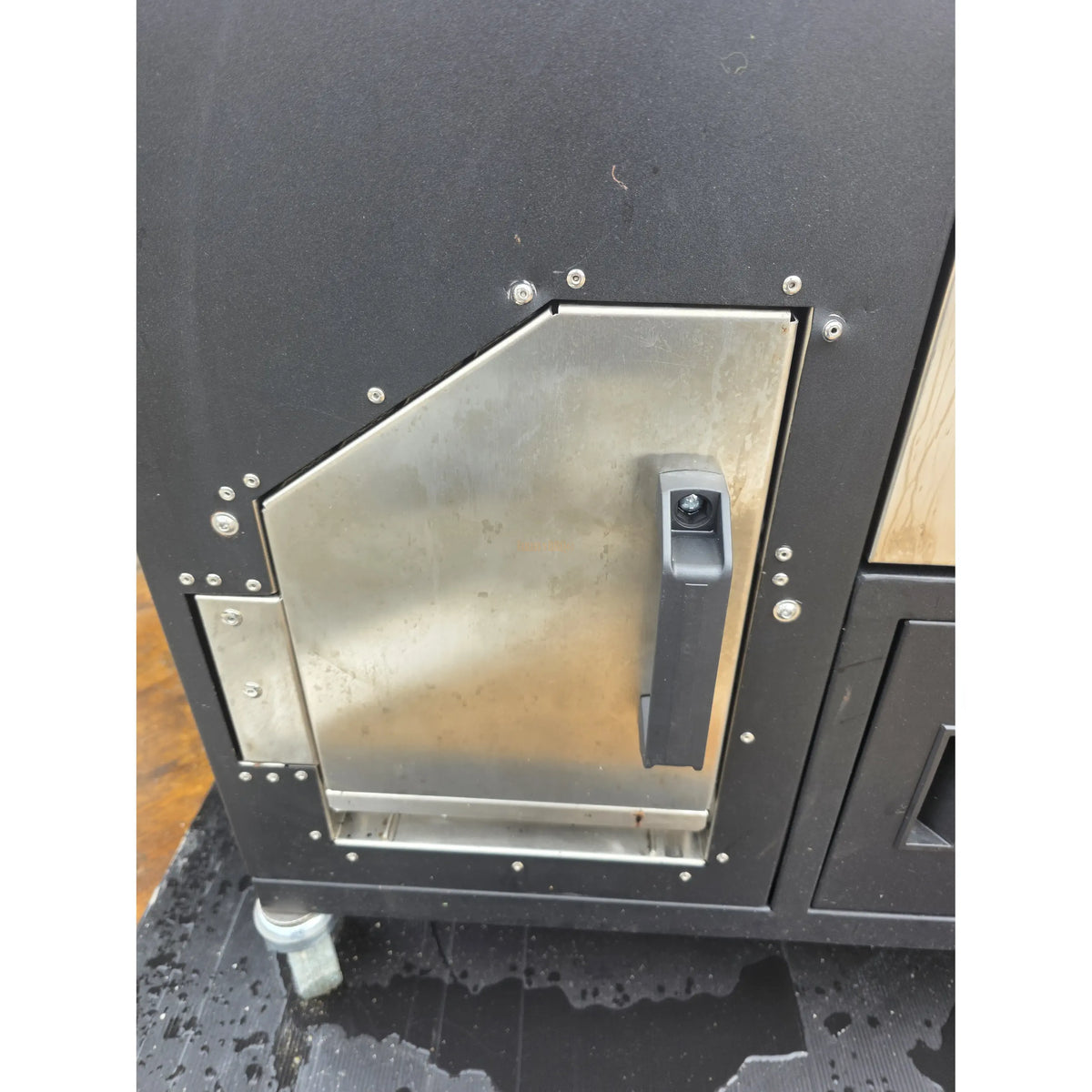 Bottom of smoker showing black textured surface