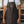 Leather BBQ Apron - Jack the Ripper by FireFly Barbecue shown worn, featuring premium brown leather with copper embossed logo and front pockets.
