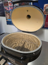 Open Primo Kamado Charcoal Grill with stainless steel grates and ceramic interior, ready for outdoor cooking use.