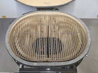 Top-down view of Primo Kamado Charcoal Grill interior with dual-zone stainless steel grates and ceramic firebox.
