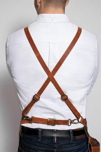 Leather cross-strap apron on man in white shirt for kitchen or BBQ use