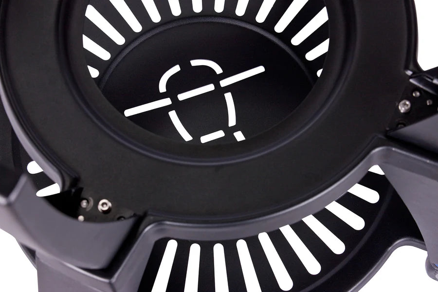Close-up of the circular grill surface with slotted design and branding