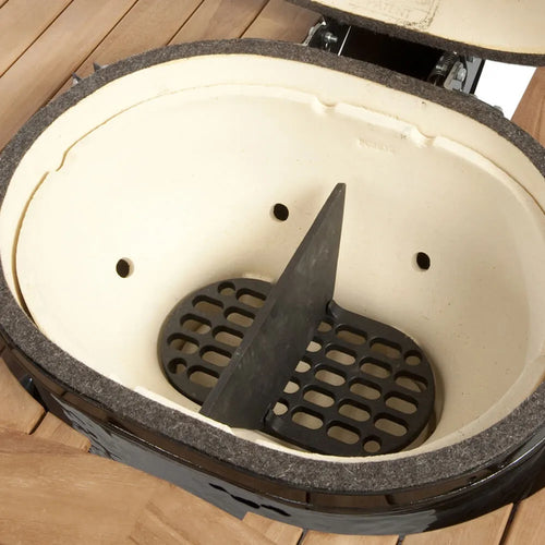 Interior view of Primo Oval XL400 ceramic grill showing heat insulation and cooking chamber
