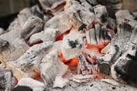 Glowing hot charcoal embers for outdoor grilling and BBQ cooking