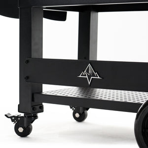 Detail of Green Mountain Grills PEAK PRIME 2.0 Pellet Grill base with caster wheels and mountain logo, designed for mobility and stability.