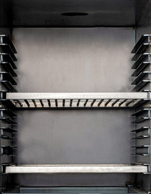 Interior view of Bertha Charcoal Oven with adjustable grill racks, ideal for high-capacity outdoor grilling and smoking.