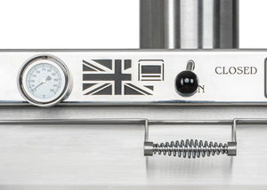 Close-up of Bertha Professional X Charcoal Oven for Compact Cooking showing UK flag emblem, temperature gauge, and control knob.