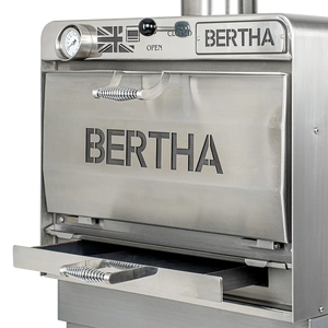 Angled view of Bertha X Charcoal Oven with open ash drawer, emphasizing its sleek design and user-friendly maintenance features.