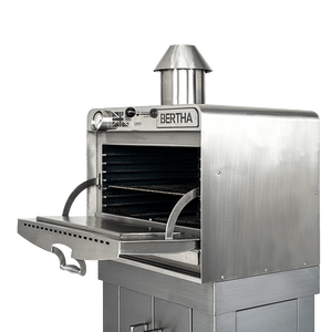 Bertha X Charcoal Oven with open front door, revealing spacious cooking chamber and ergonomic handle design for outdoor grilling.