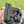 Hand holding charcoal pieces outdoors for barbecue