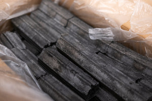 Close-up of Sumi Bincho Charcoal (10kg Box) with uniform shape and texture, designed for consistent heat in outdoor grill accessories.