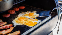 Grilled eggs and bacon on a portable grill