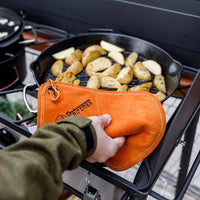 Petromax Aramid Potholders protecting hands while cooking on grill