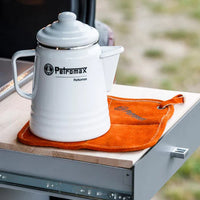 Petromax Aramid Potholders on outdoor kitchen table with teapot