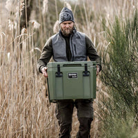 Outdoor man carrying Petromax 25L Cool Box in nature