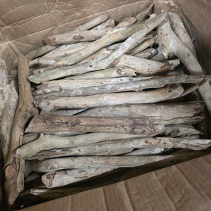 Assorted rustic wood pieces in a cardboard box