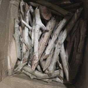 Pile of aged wooden branches for garden decoration