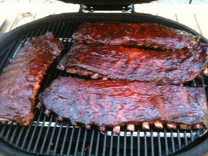 Primo grill with cooked ribs on grill surface