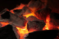 Glowing hot charcoal embers for outdoor grilling and barbecues