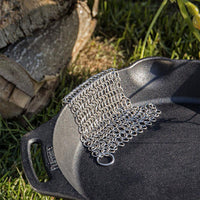 Chain mail cleaner on cast iron pan for cleaning