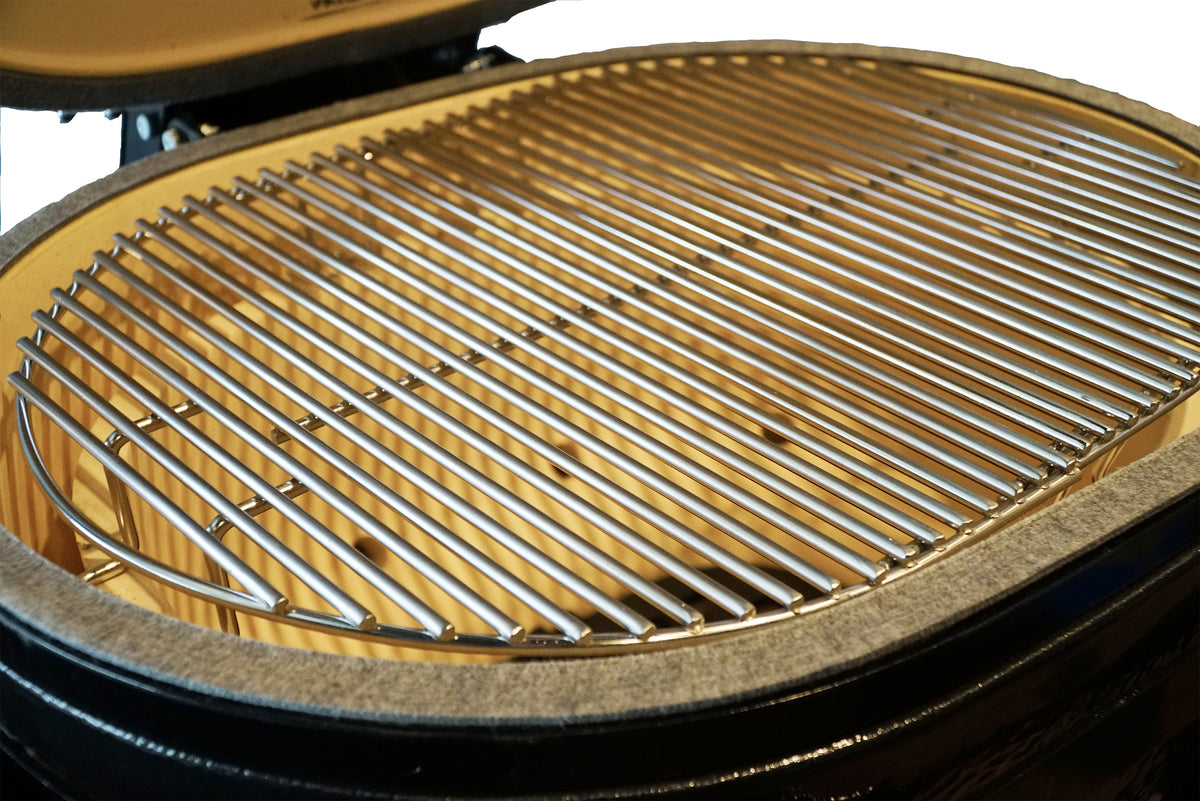 Stainless steel cooking grate inside Primo Oval JR 200 Ceramic BBQ Grill, providing ample space for grilling meats and vegetables.