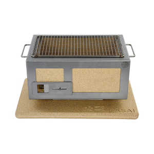 Kasai Konro BBQ Grill with Steel Frame V2 placed on a cork base, emphasizing its heat protection and stylish outdoor grilling setup.
