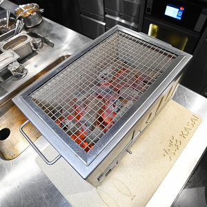 Kasai Konro Heat Mat in use under a Nano Grill in a professional kitchen, ensuring safe and efficient grilling on countertops.