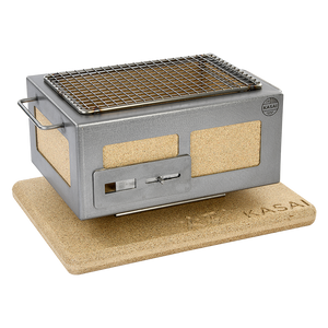 Side angle of Nano Pro Kasai BBQ Stainless Steel Grill on cork base, showcasing its compact and portable design for outdoor use.