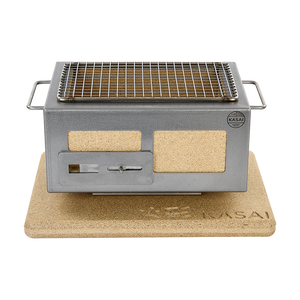 Front-facing Nano Pro Kasai BBQ Stainless Steel Grill on cork mat, highlighting its sturdy build and traditional Japanese BBQ style.