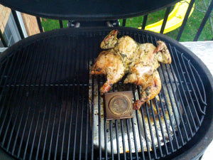 Close-up of Primo grill with chicken and vegetables on cooking surface